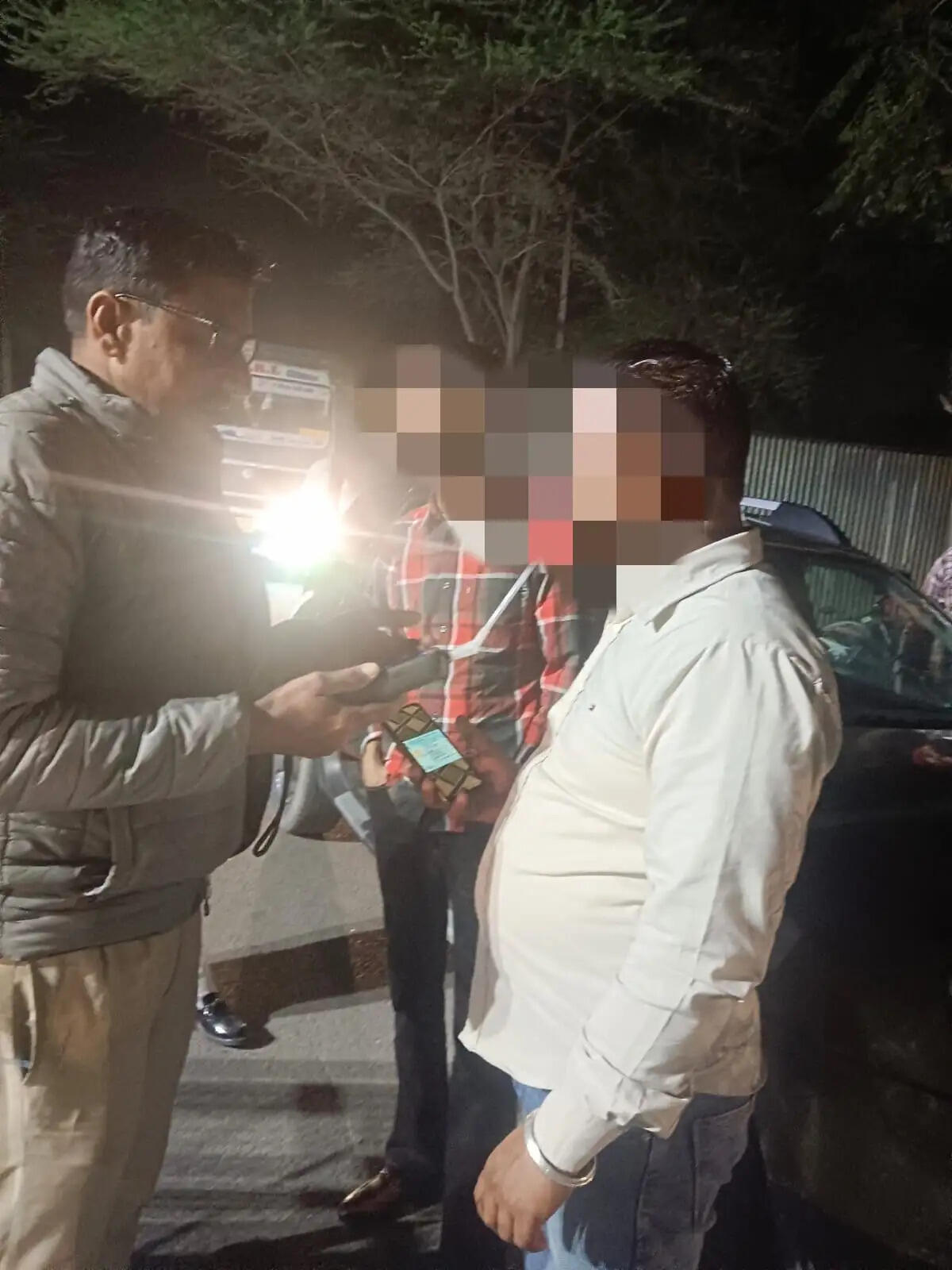 Dabwali Traffic Police personnel checking vehicles and removing bullet motorcycle silencers during a road safety drive.